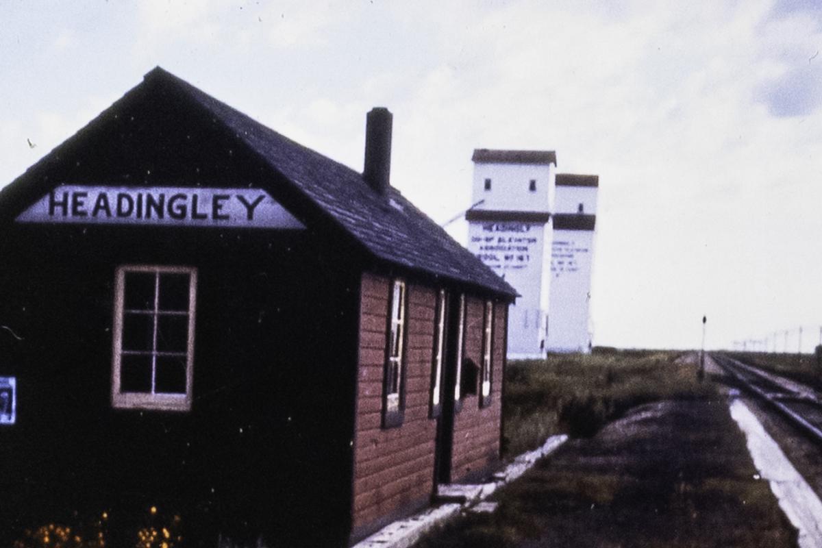 Headingley Railway Station and Coop Elevator train stopped for passengers, mail, grain, flour, and milk shipment to Winnipeg. Moved July 1994