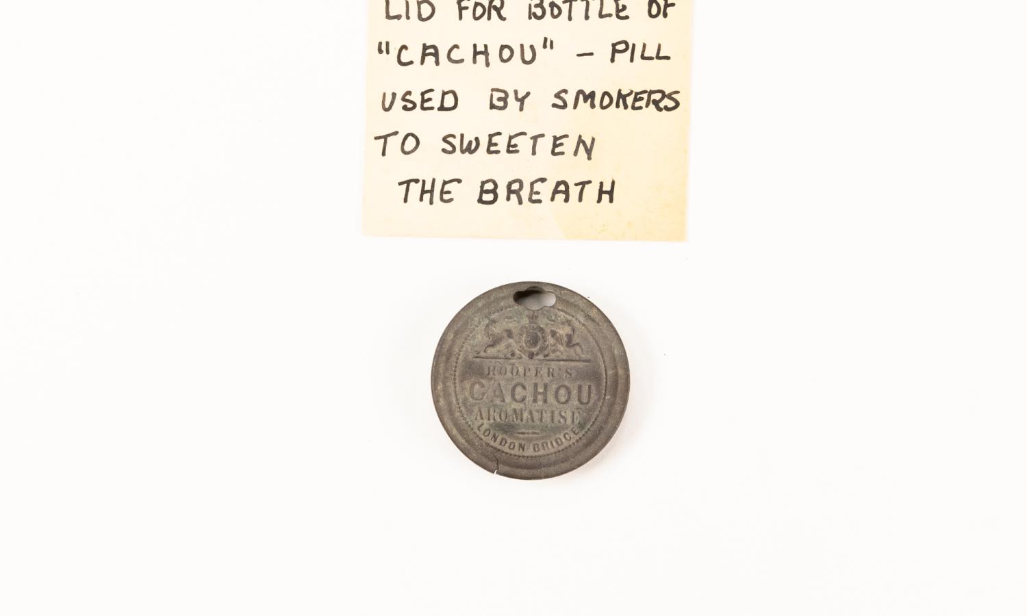 Lid for bottle of "Cachou" pills used by smokers to sweeten the breath