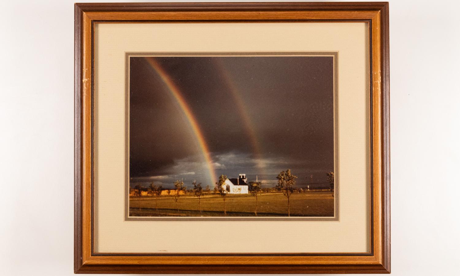 Framed image taken of double rainbow over rural church