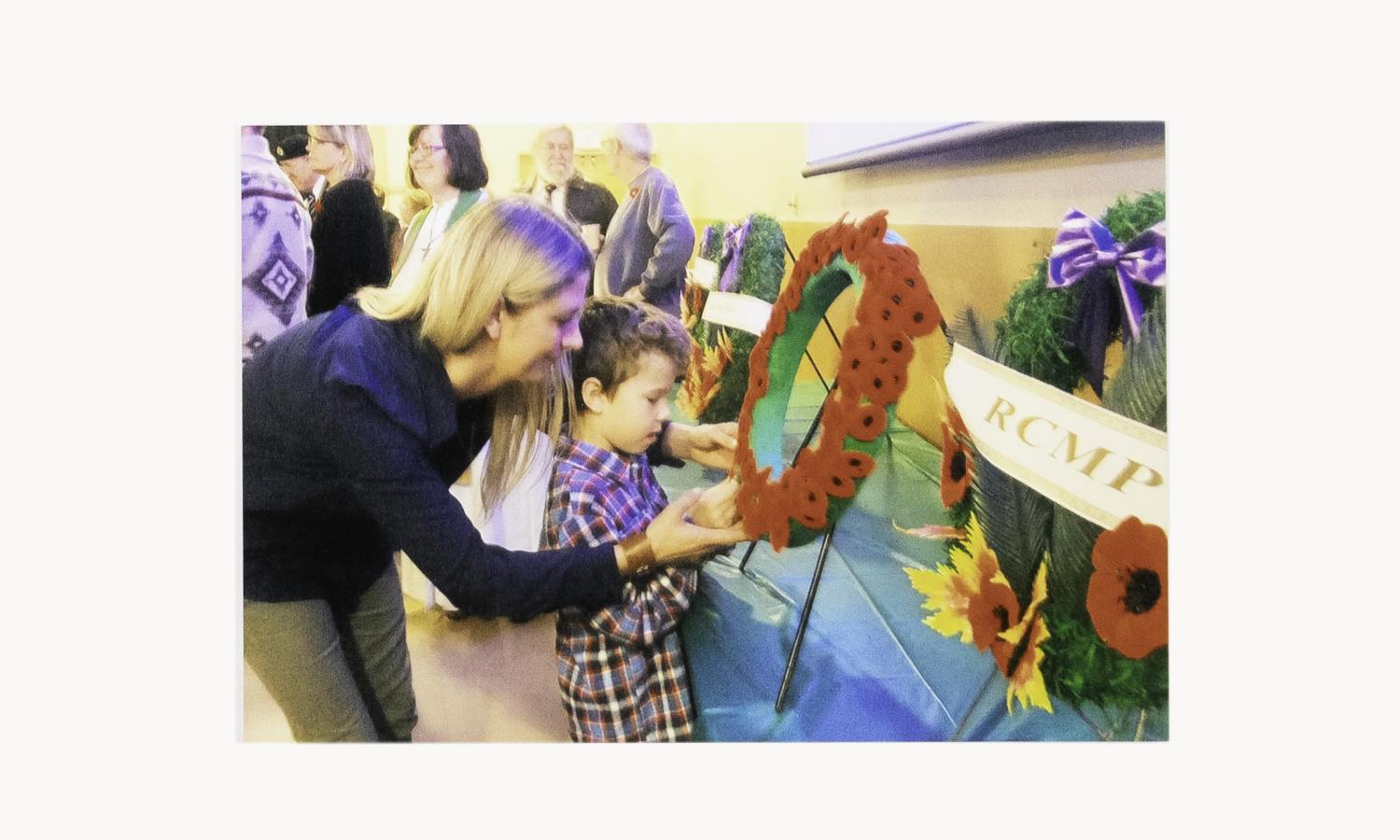 Mother and son place wreath 