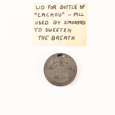 Lid for bottle of "Cachou" pills used by smokers to sweeten the breath