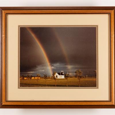 Framed image taken of double rainbow over rural church